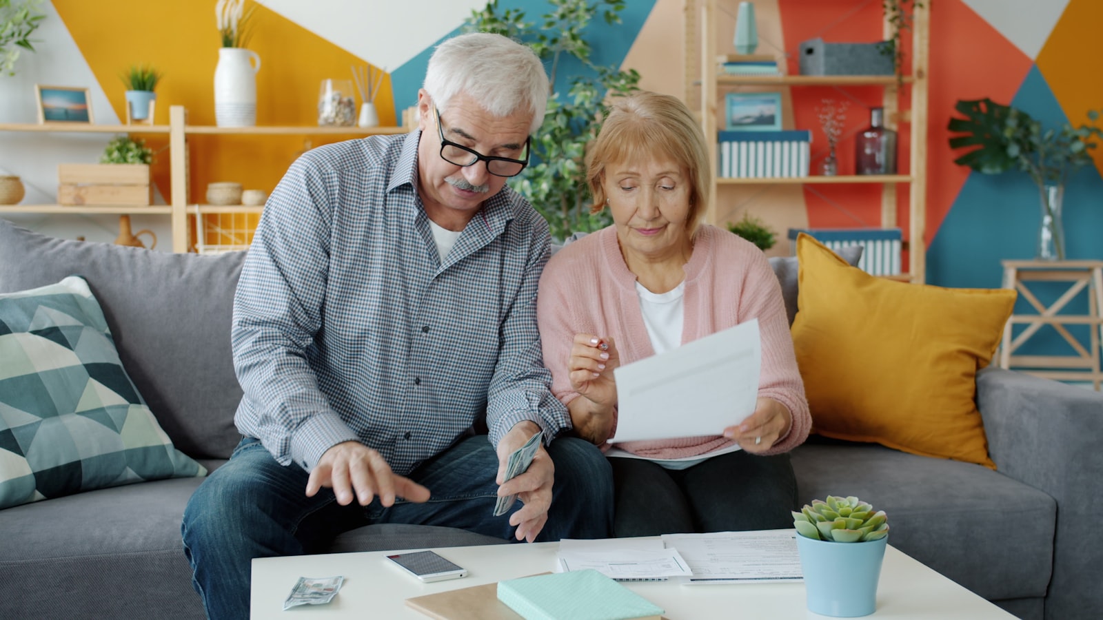 Couple reviewing finances and estate documents at home