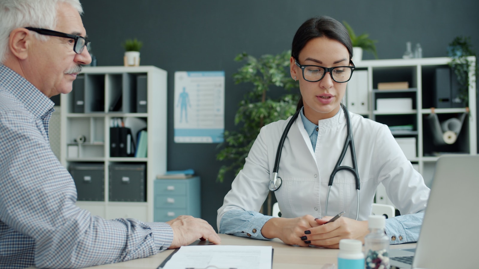 Older patient discussing medications with a doctor